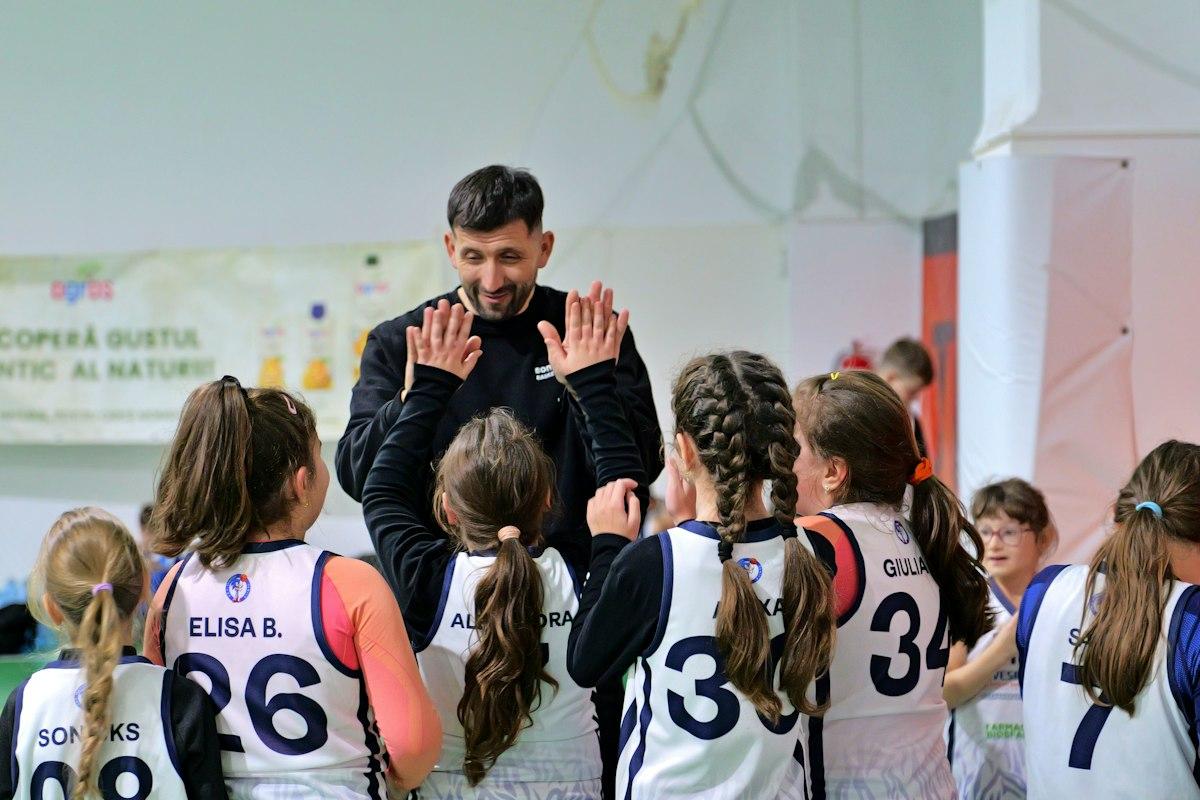 A sports coach mentoring and training a student athlete on the court