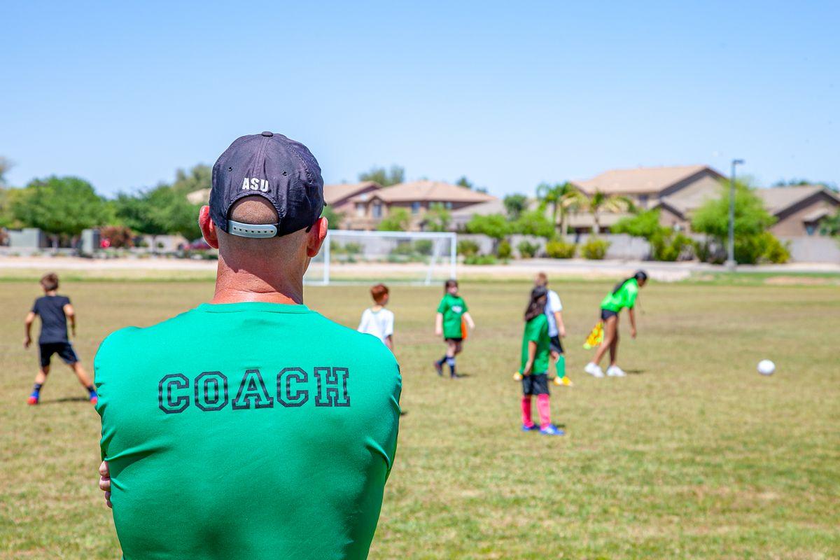 A coach running a training session for a batch of players